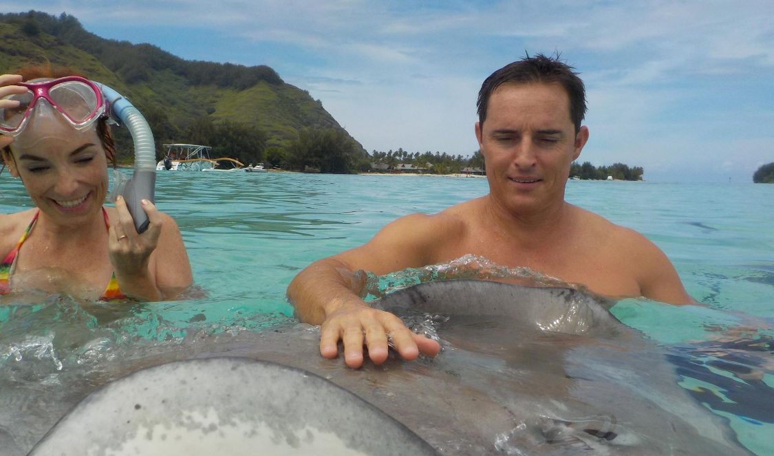 touching rays in Moorea lagoon during your holiday